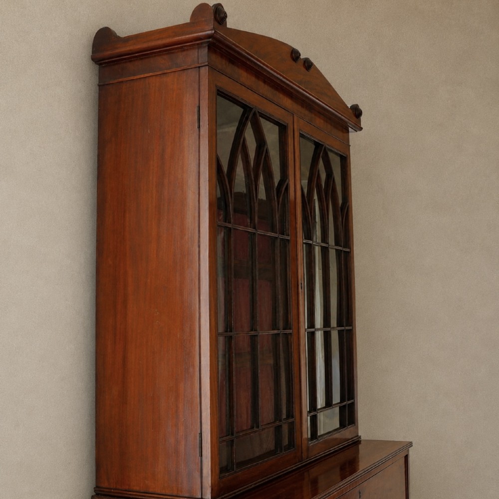 A nineteenth-century George IV mahogany secretaire bookcase with glazed upper doors featuring gothic tracery and a drop-down desk drawer revealing a fitted interior. View XII