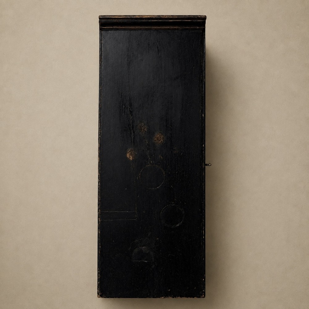 An ebonised black wooden wall cabinet featuring an arched door panel decorated with a hand-painted exotic bird amongst green foliage. View IV