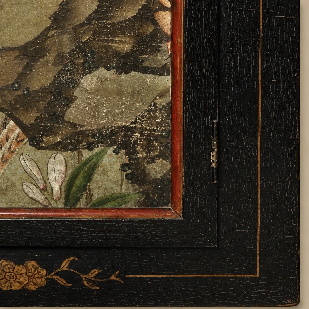 An ebonised black wooden wall cabinet featuring an arched door panel decorated with a hand-painted exotic bird amongst green foliage. View IX