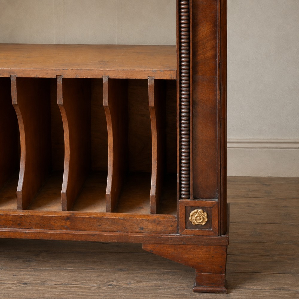 A nineteenth-century French Empire style rosewood open bookcase featuring brass mounts and adjustable shelves above vertical dividers. View V