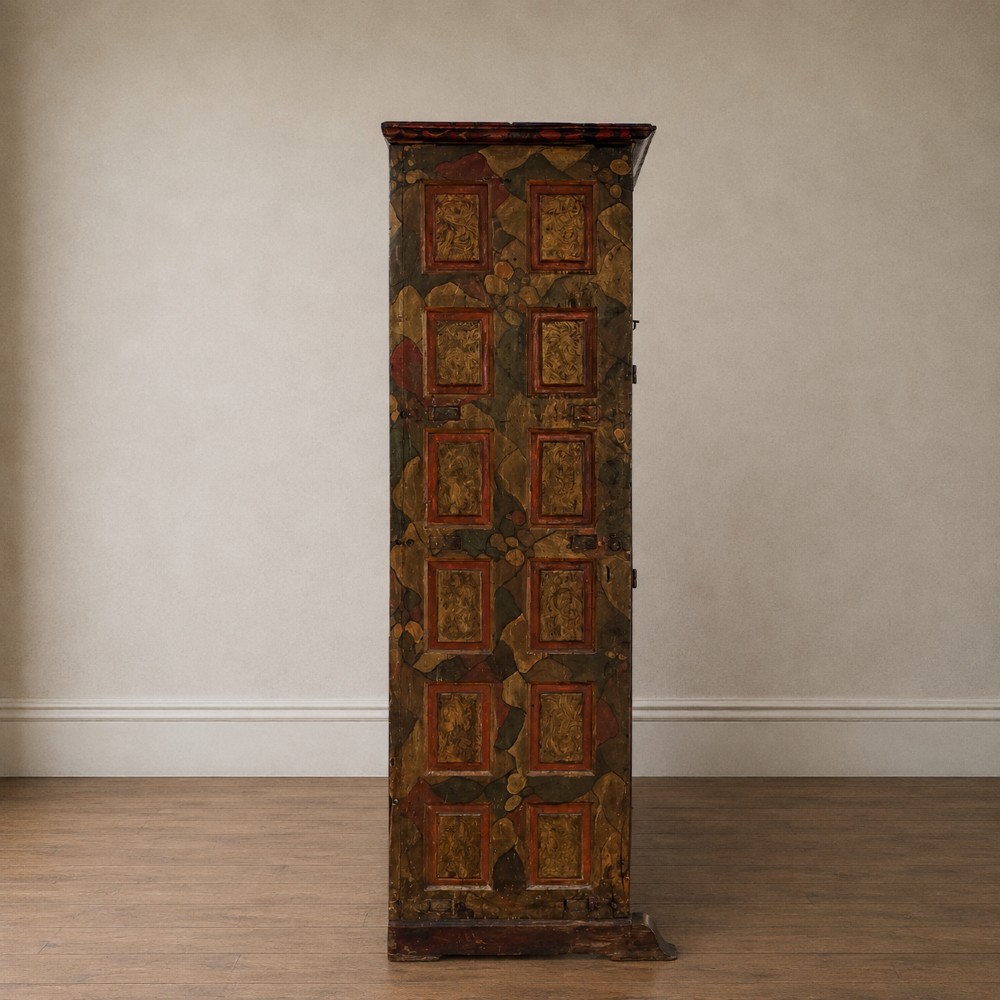 A tall seventeenth-century Spanish oak press cupboard featuring double upper and lower doors decorated with geometric raised panels and painted polychrome geometric patterns. View V