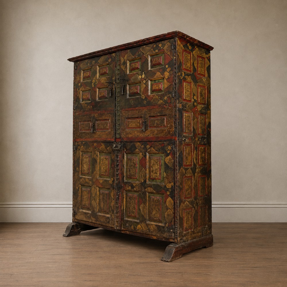 A tall seventeenth-century Spanish oak press cupboard featuring double upper and lower doors decorated with geometric raised panels and painted polychrome geometric patterns. View VII