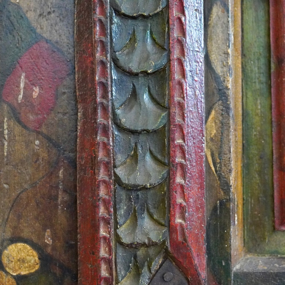 A tall seventeenth-century Spanish oak press cupboard featuring double upper and lower doors decorated with geometric raised panels and painted polychrome geometric patterns. View XI