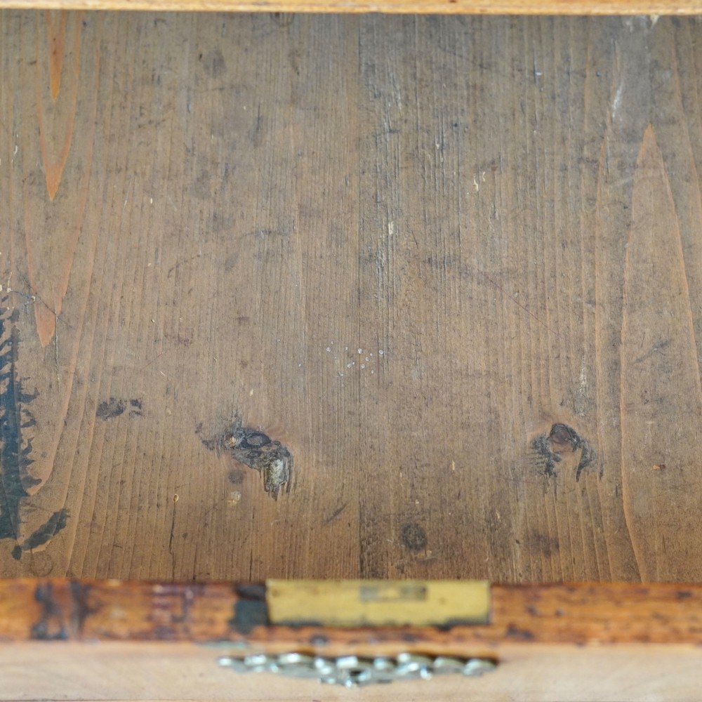 An Early Georgian walnut bureau featuring a sloping drop-front writing lid, four graduated drawers with brass drop handles, and bracket feet. View XV