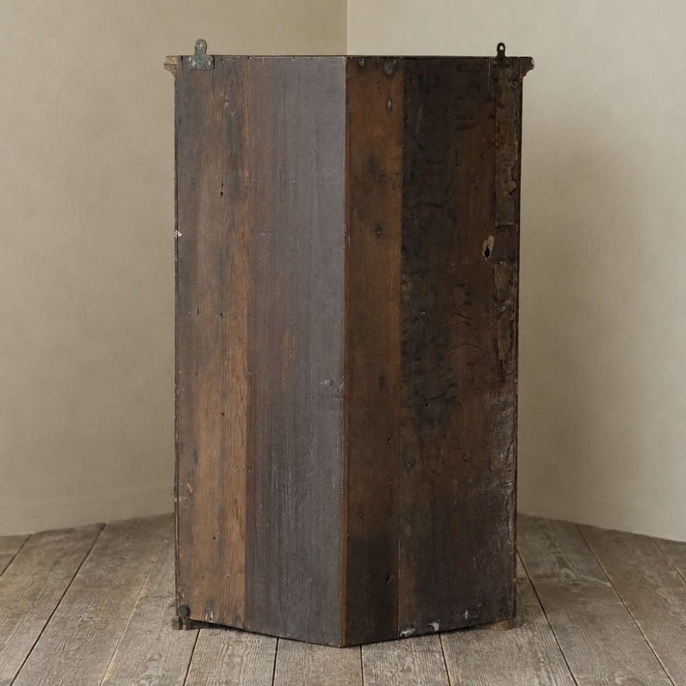A nineteenth-century bow-front corner cupboard crafted in dark black lacquer with gold hand-painted chinoiserie figures and architectural scenes. View V