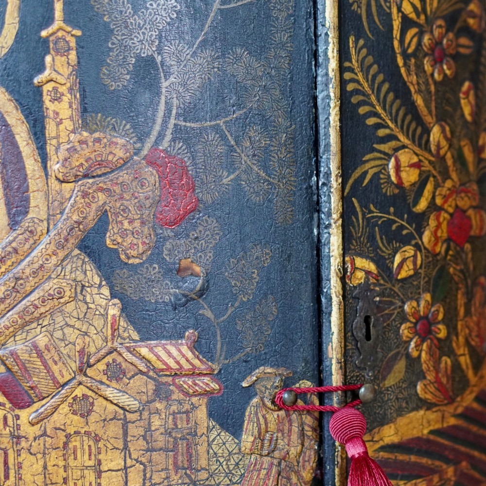 A nineteenth-century bow-front corner cupboard crafted in dark black lacquer with gold hand-painted chinoiserie figures and architectural scenes. View VIII