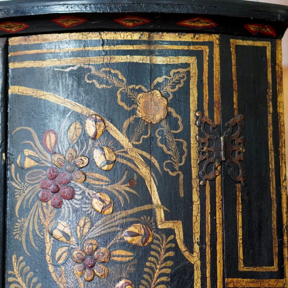 A nineteenth-century bow-front corner cupboard crafted in dark black lacquer with gold hand-painted chinoiserie figures and architectural scenes. View X