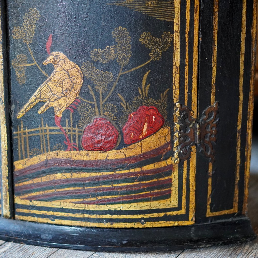 A nineteenth-century bow-front corner cupboard crafted in dark black lacquer with gold hand-painted chinoiserie figures and architectural scenes. View XI