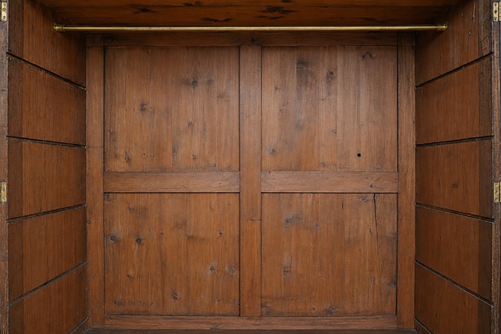 A large George III mahogany breakfront linen press wardrobe featuring central panelled doors above drawers, flanked by side cupboards on bracket feet. View XII