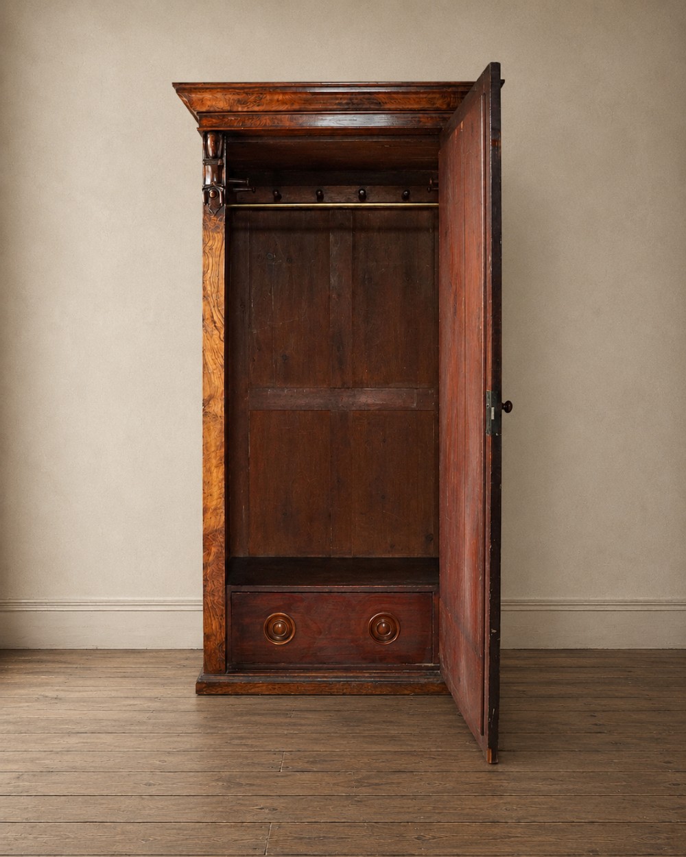 A Victorian single-door wardrobe crafted from figured walnut wood, featuring a central arch-topped mirror panel, carved corbels, and a heavy moulded cornice. View II