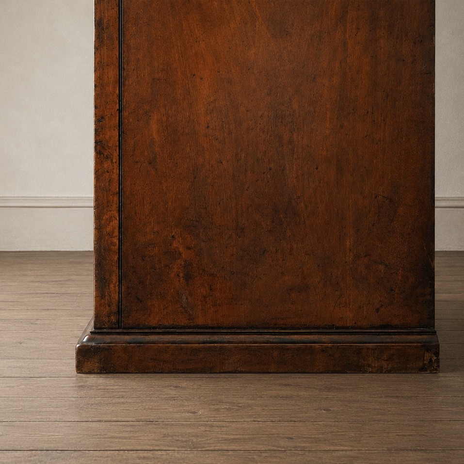 A Victorian single-door wardrobe crafted from figured walnut wood, featuring a central arch-topped mirror panel, carved corbels, and a heavy moulded cornice. View VI