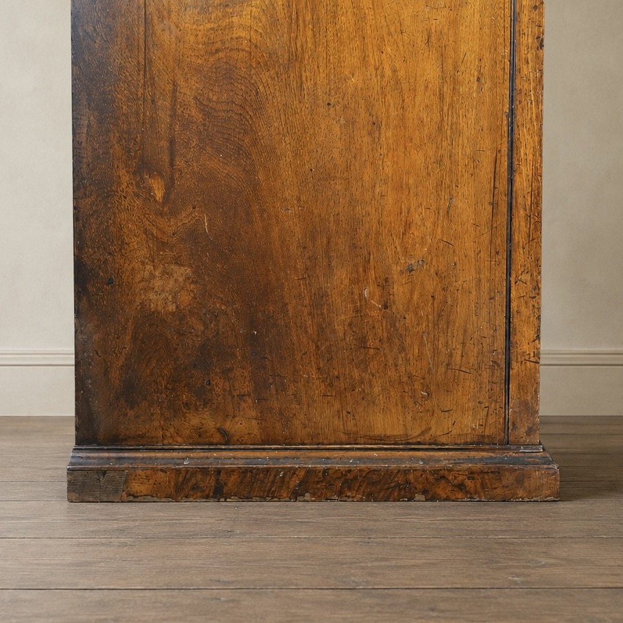 A Victorian single-door wardrobe crafted from figured walnut wood, featuring a central arch-topped mirror panel, carved corbels, and a heavy moulded cornice. View XI