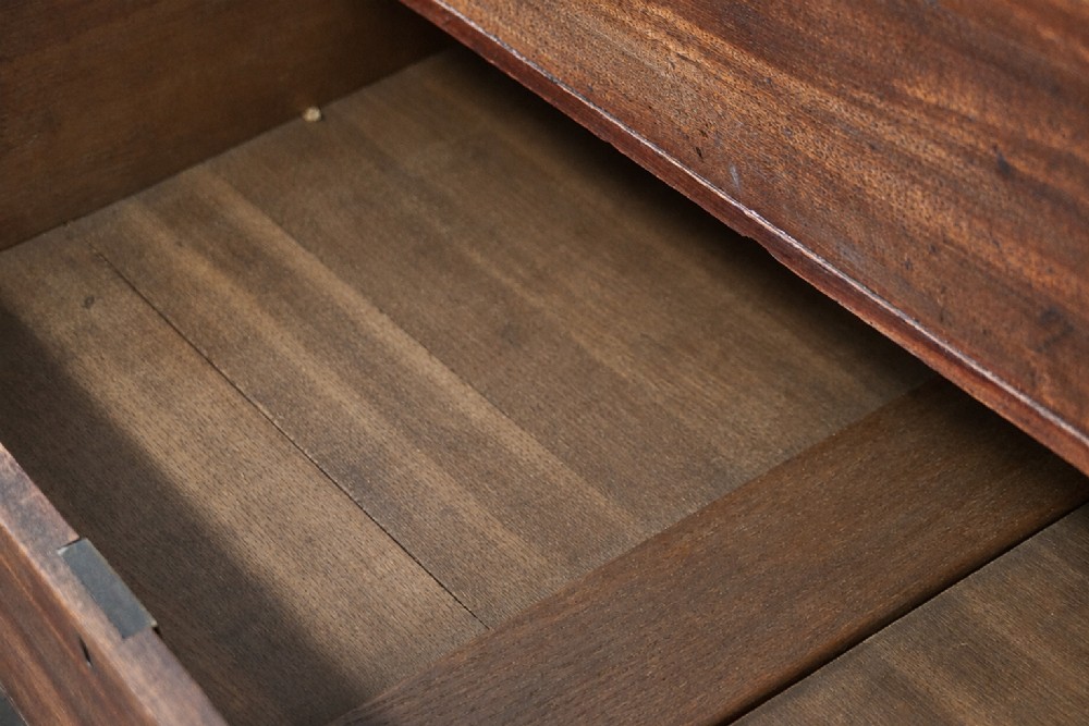 A large George III mahogany breakfront linen press wardrobe featuring central panelled doors above drawers, flanked by side cupboards on bracket feet. View XV