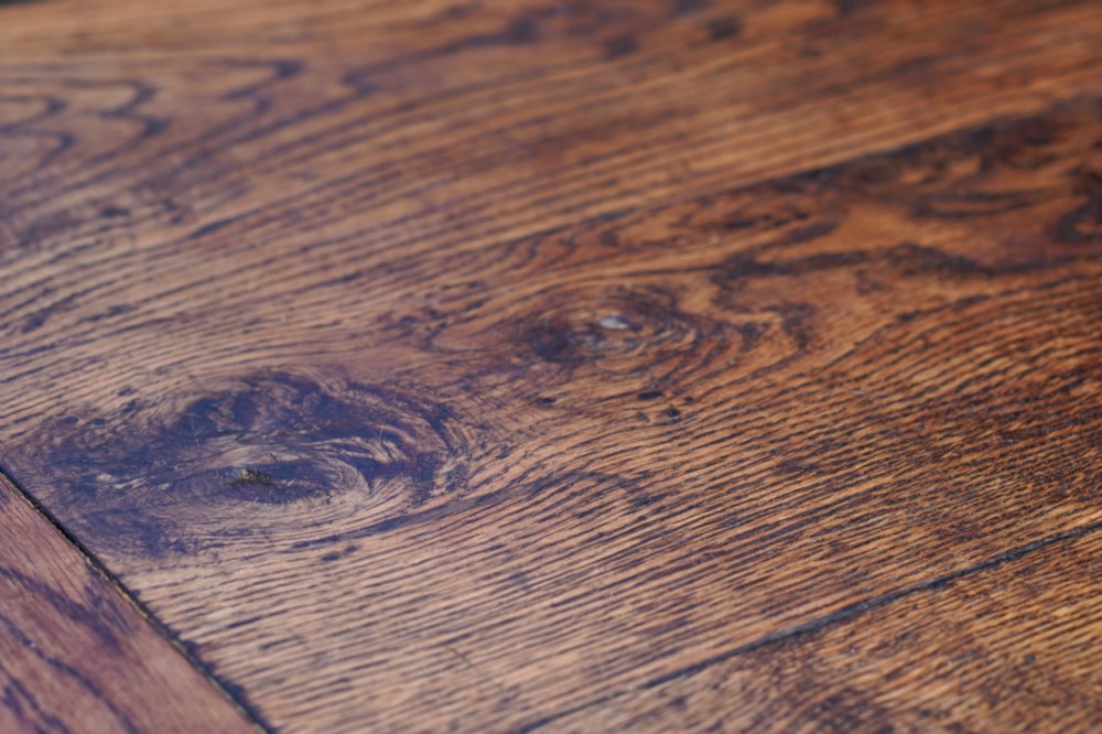 A 17th-century solid oak extending dining table featuring turned legs, lower stretcher rails, and two draw-out end leaves. View XIV