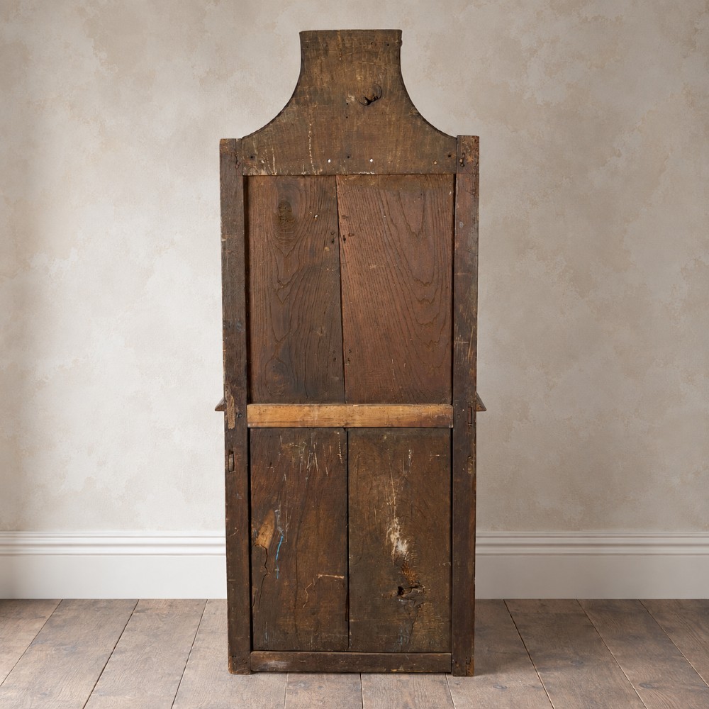 An 18th-century dark chestnut wood lavabo cabinet featuring a carved backboard mounted with a pewter cistern above a matching pewter basin. View IV