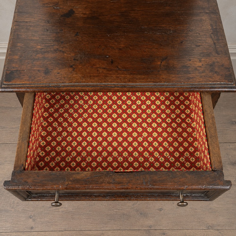 An 18th-century dark chestnut wood lavabo cabinet featuring a carved backboard mounted with a pewter cistern above a matching pewter basin. View XII