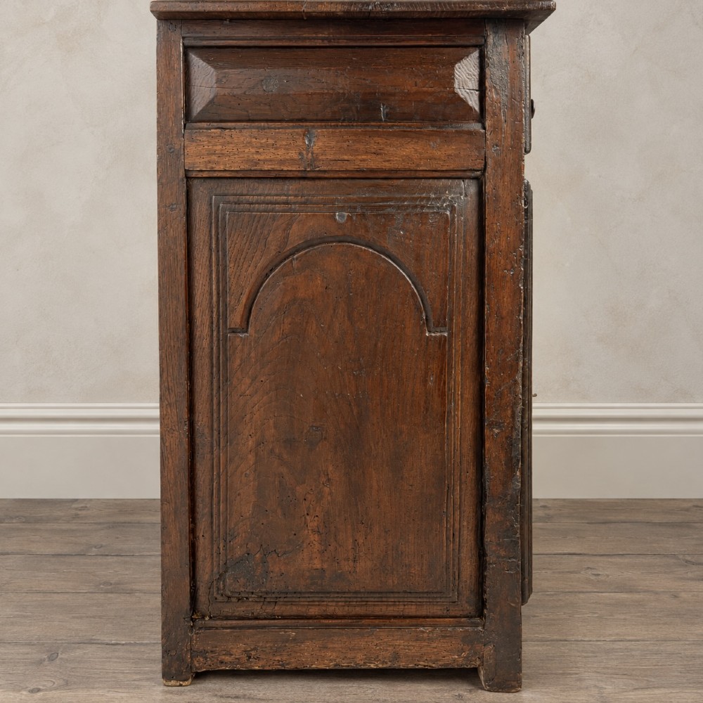 An 18th-century dark chestnut wood lavabo cabinet featuring a carved backboard mounted with a pewter cistern above a matching pewter basin. View XIII