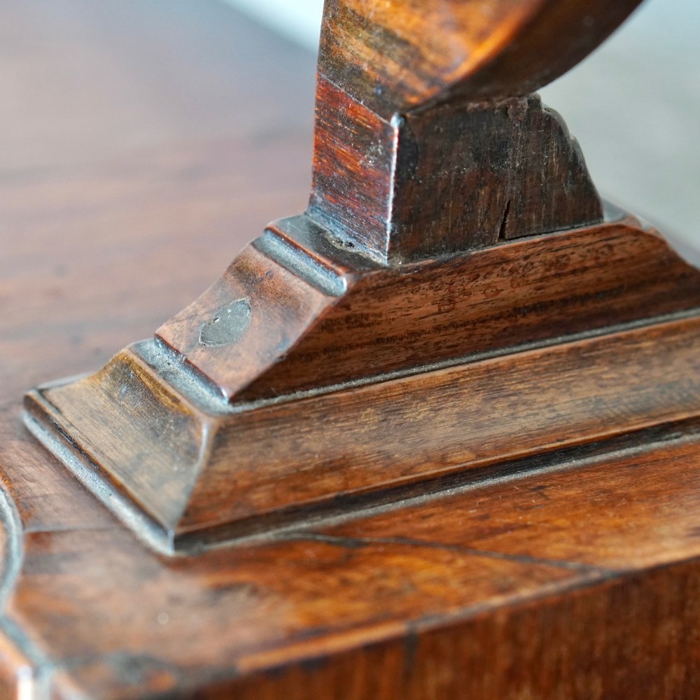 An antique Queen Anne walnut and laburnum toilet mirror featuring an arched cross-banded frame above a serpentine base with miniature drawers. View XIII