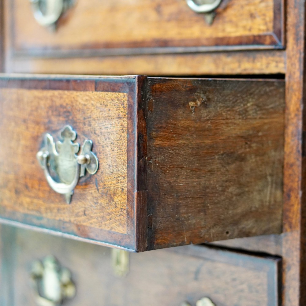 A George II dark oak dresser with a tall open plate rack above a sideboard featuring multiple drawers and twin cupboard doors. View XII