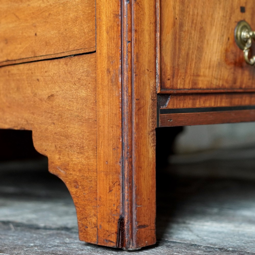 A 19th-century mahogany tray top night commode featuring two cabinet doors with oval marquetry inlays above two drawers with brass handles. View XI