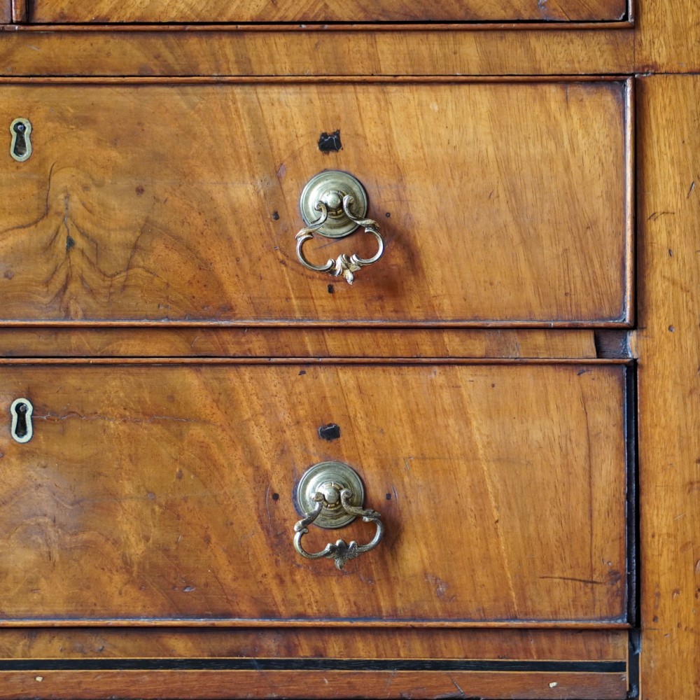 A 19th-century mahogany tray top night commode featuring two cabinet doors with oval marquetry inlays above two drawers with brass handles. View XIII