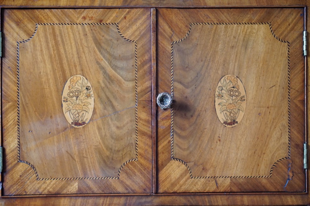 A 19th-century mahogany tray top night commode featuring two cabinet doors with oval marquetry inlays above two drawers with brass handles. View XIV