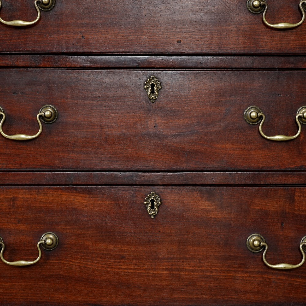 A George III mahogany chest on chest featuring two short over six long graduated drawers, a brushing slide, blind fretwork frieze, brass swan-neck handles, and bracket feet. View VIII