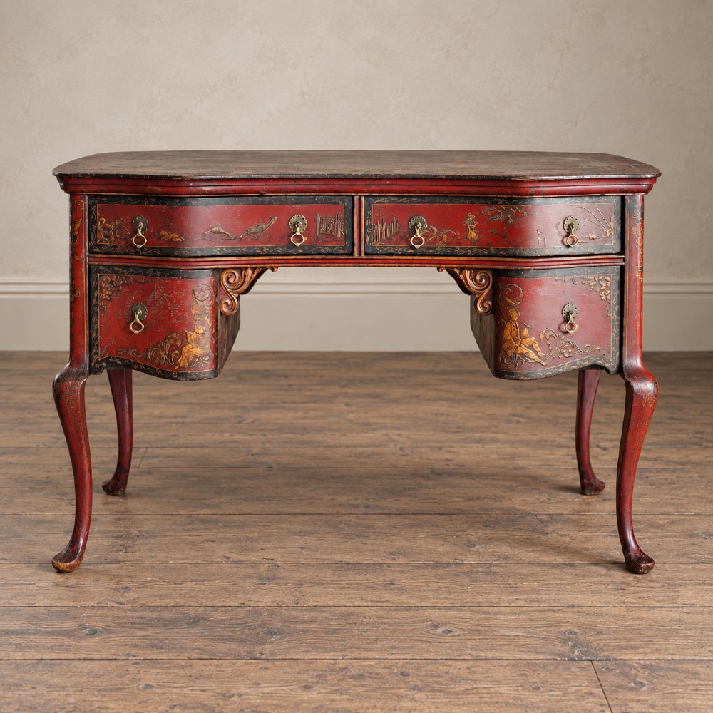A late nineteenth-century kidney-shaped red lacquered Chinoiserie dressing table featuring four drawers, hand-painted oriental scenes, and cabriole legs.