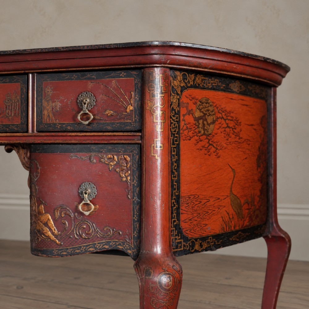 A late nineteenth-century kidney-shaped red lacquered Chinoiserie dressing table featuring four drawers, hand-painted oriental scenes, and cabriole legs. View II