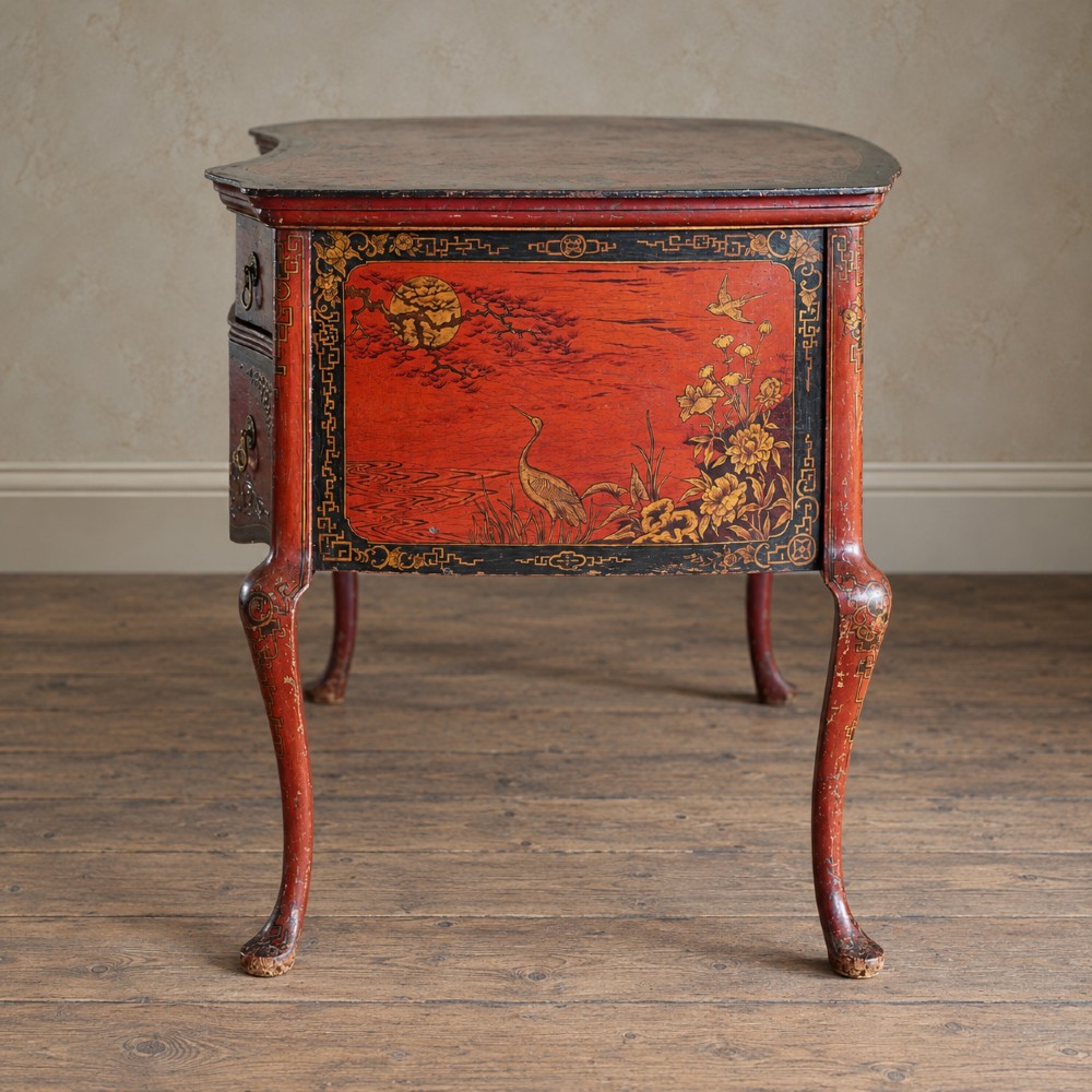 A late nineteenth-century kidney-shaped red lacquered Chinoiserie dressing table featuring four drawers, hand-painted oriental scenes, and cabriole legs. View VI