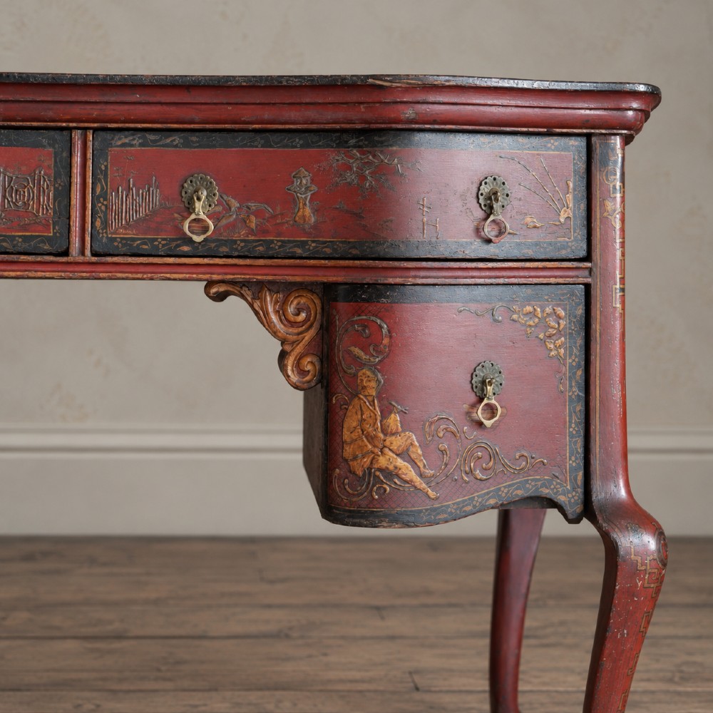 A late nineteenth-century kidney-shaped red lacquered Chinoiserie dressing table featuring four drawers, hand-painted oriental scenes, and cabriole legs. View IX