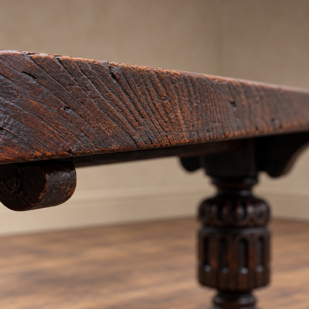 A 17th-century oak and elm refectory dining table featuring a solid single-plank top over thick carved bulbous pedestal supports and a low central stretcher rail. View VIII
