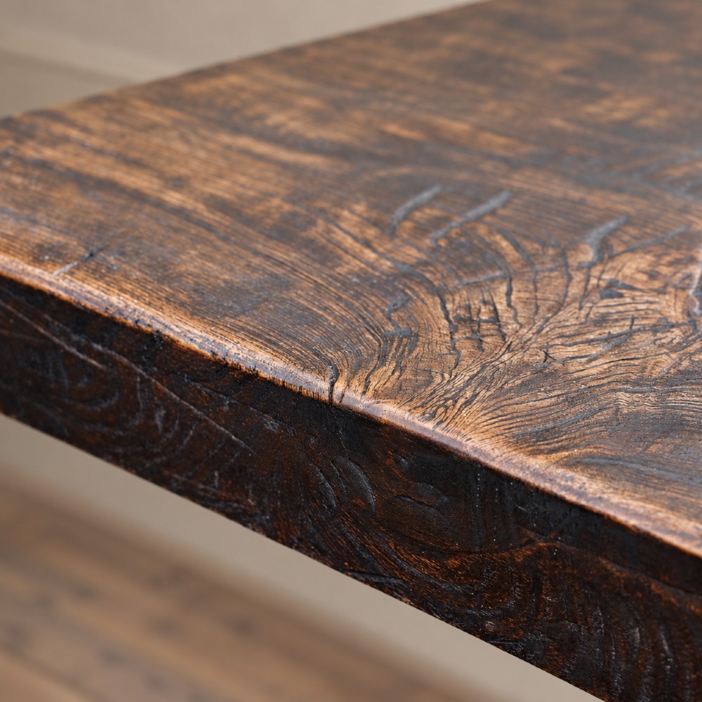 A 17th-century oak and elm refectory dining table featuring a solid single-plank top over thick carved bulbous pedestal supports and a low central stretcher rail. View IX