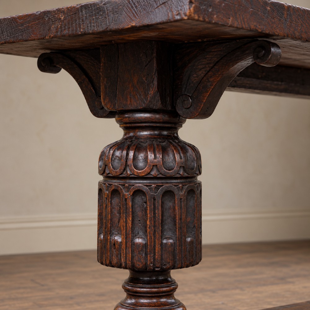 A 17th-century oak and elm refectory dining table featuring a solid single-plank top over thick carved bulbous pedestal supports and a low central stretcher rail. View XI