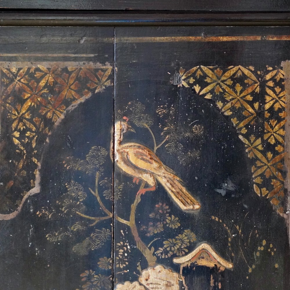 An 18th-century black japanned single-door wall corner cupboard featuring hand-painted gold Chinoiserie figures, architectural motifs, and brass butterfly hinges. View III
