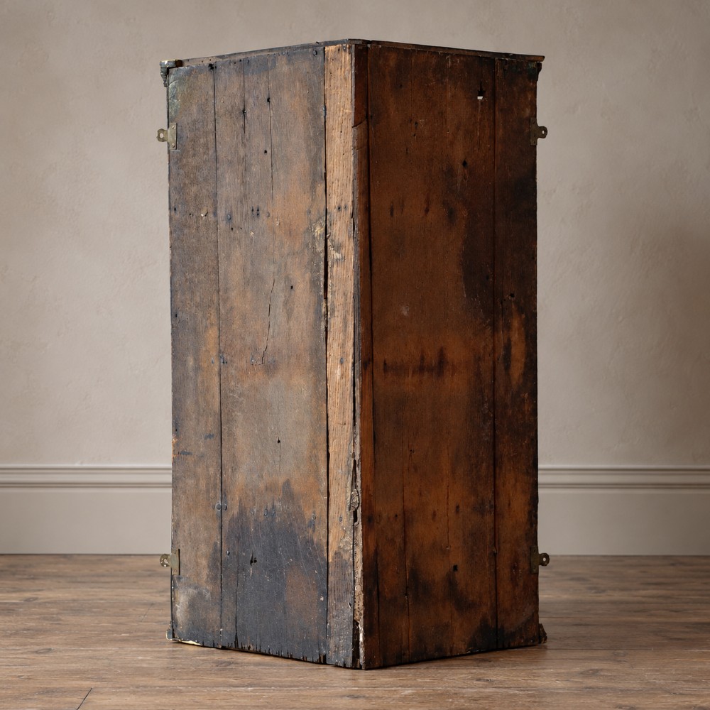 An 18th-century black japanned single-door wall corner cupboard featuring hand-painted gold Chinoiserie figures, architectural motifs, and brass butterfly hinges. View VI