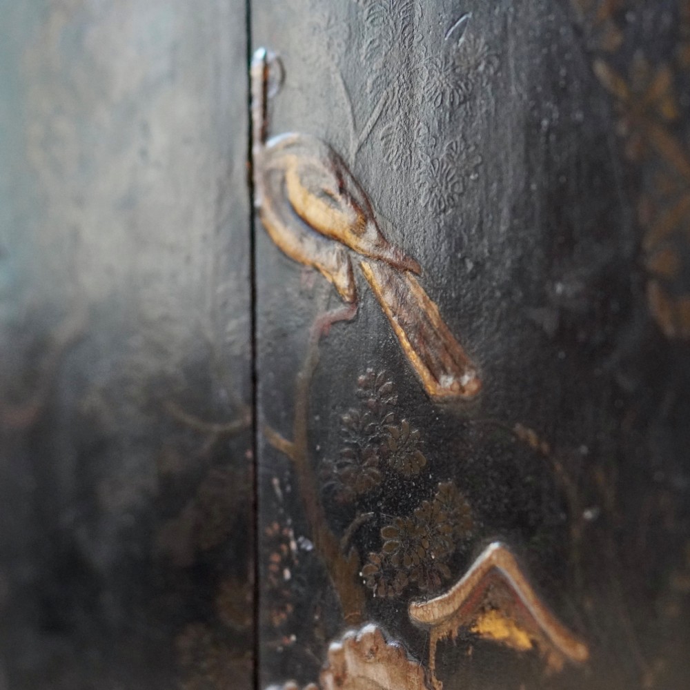 An 18th-century black japanned single-door wall corner cupboard featuring hand-painted gold Chinoiserie figures, architectural motifs, and brass butterfly hinges. View VIII