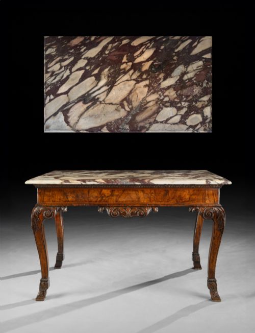fig 1. An 18th-century George II carved walnut side table featuring a variegated marble top, carved frieze, and cabriole legs with leaf details.