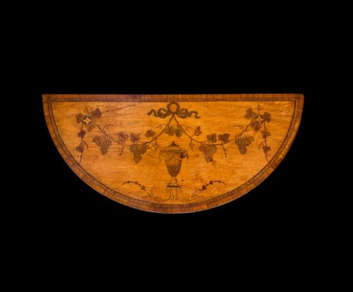 fig 3. A pair of George III period semi-circular satinwood side tables featuring inlaid marquetry tops and square tapered legs.