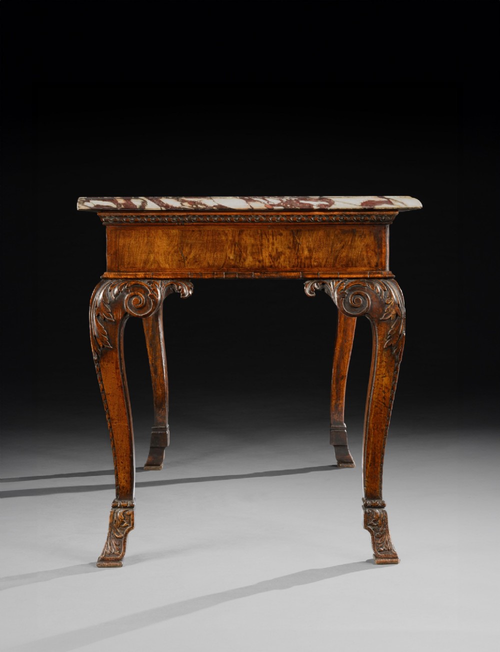 An 18th-century George II carved walnut side table featuring a variegated marble top, carved frieze, and cabriole legs with leaf details. View III