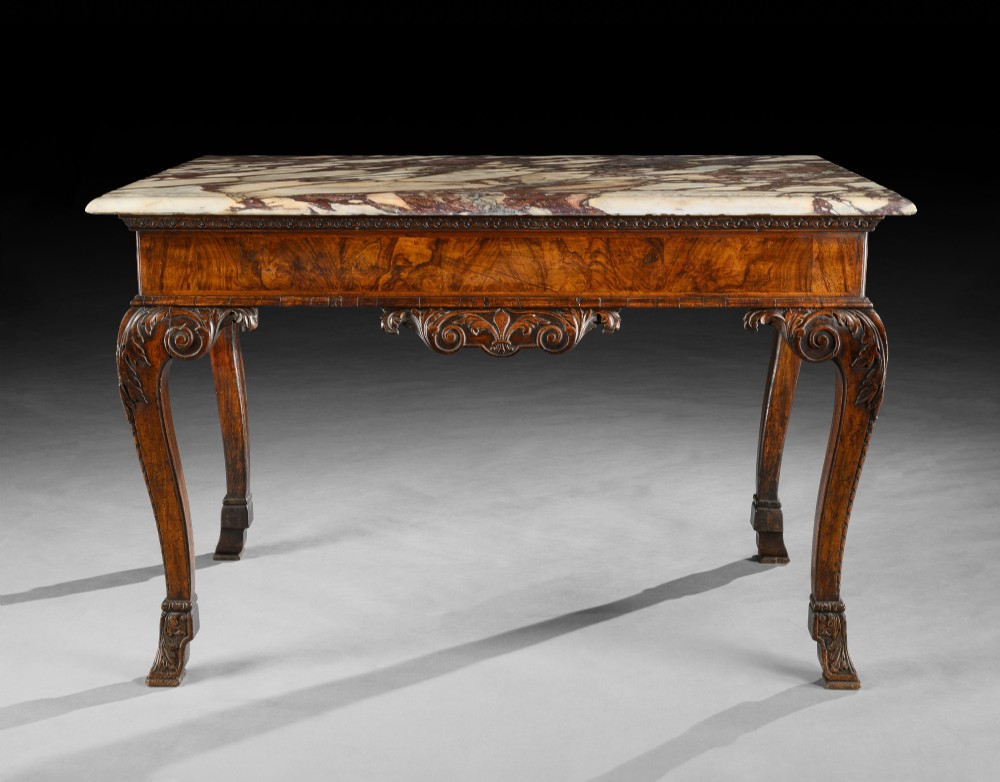 An 18th-century George II carved walnut side table featuring a variegated marble top, carved frieze, and cabriole legs with leaf details. View IV