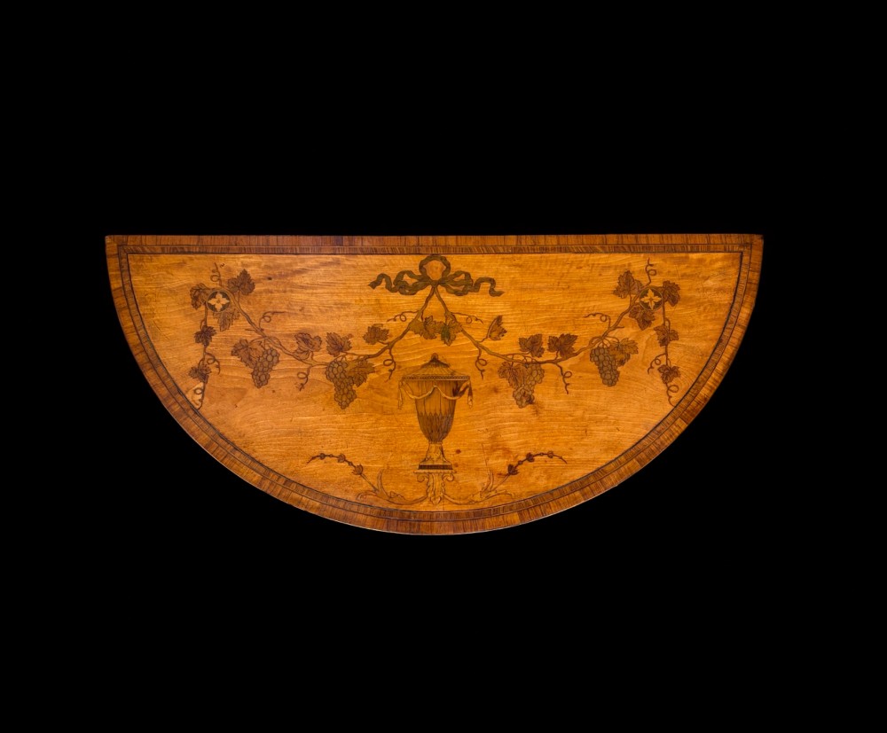 A pair of George III period semi-circular satinwood side tables featuring inlaid marquetry tops and square tapered legs. View IV