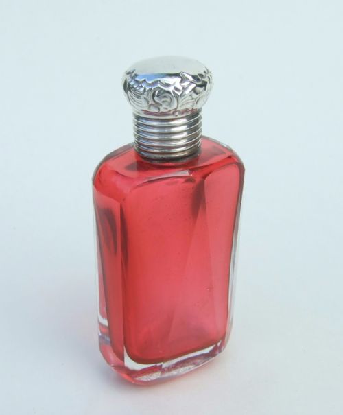 A Delightful Silver Mounted Cranberry Perfume Bottle from the Late Victorian Period.