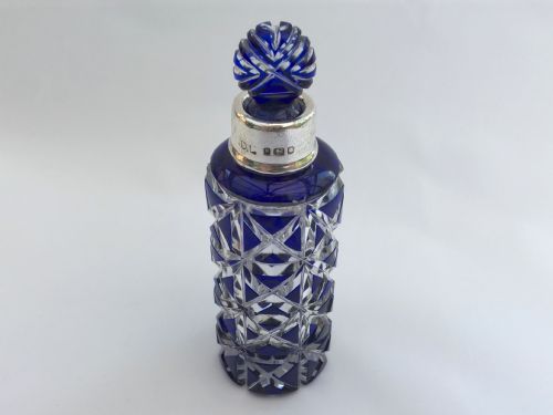 A Splendid Silver Mounted Overlay Perfume Bottle with Original Stopper