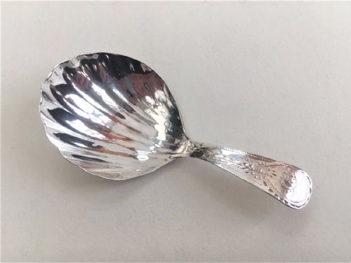 An 18th Century Silver Caddy Spoon.