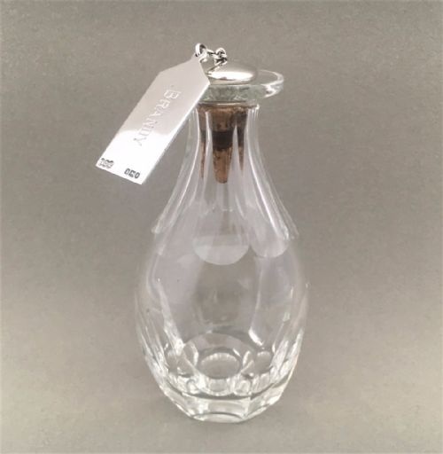 An Unusual and Rare Silver Brandy Label, Stopper and Solo Glass Decanter.