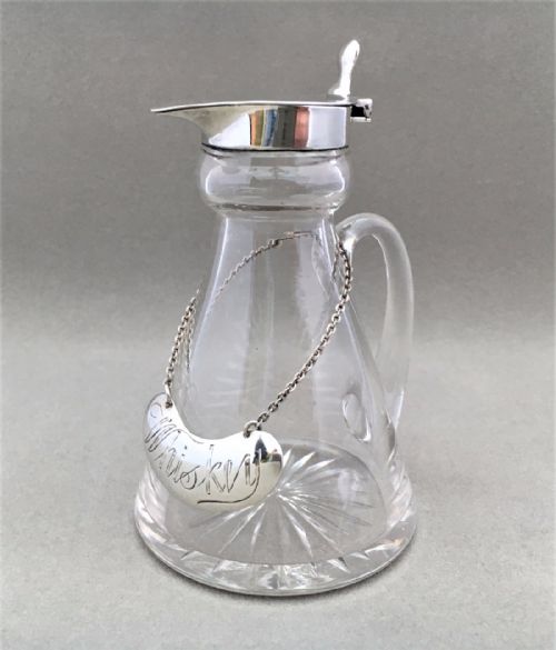 A Silver Mounted 'Whiskey' Tot with Silver Label.