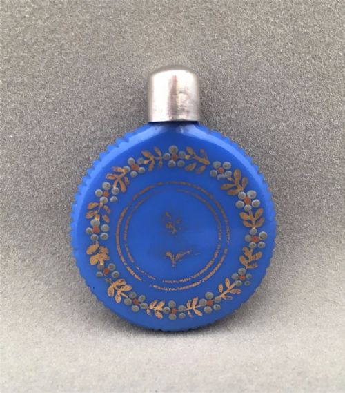 A French Silver Mounted Coin Shaped Scent Bottle.