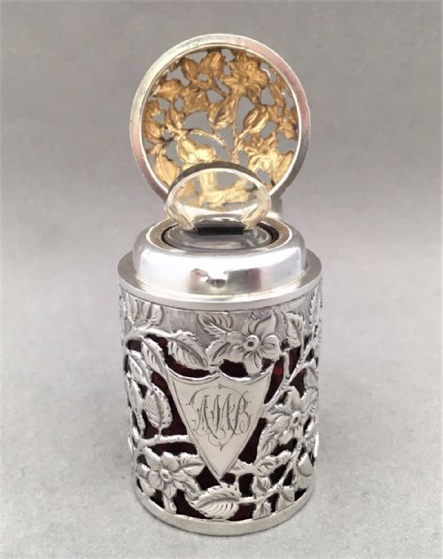 A Stunning Victorian Silver Cased Cologne Bottle.