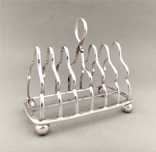 An Early George V Six Slice Silver Toast Rack